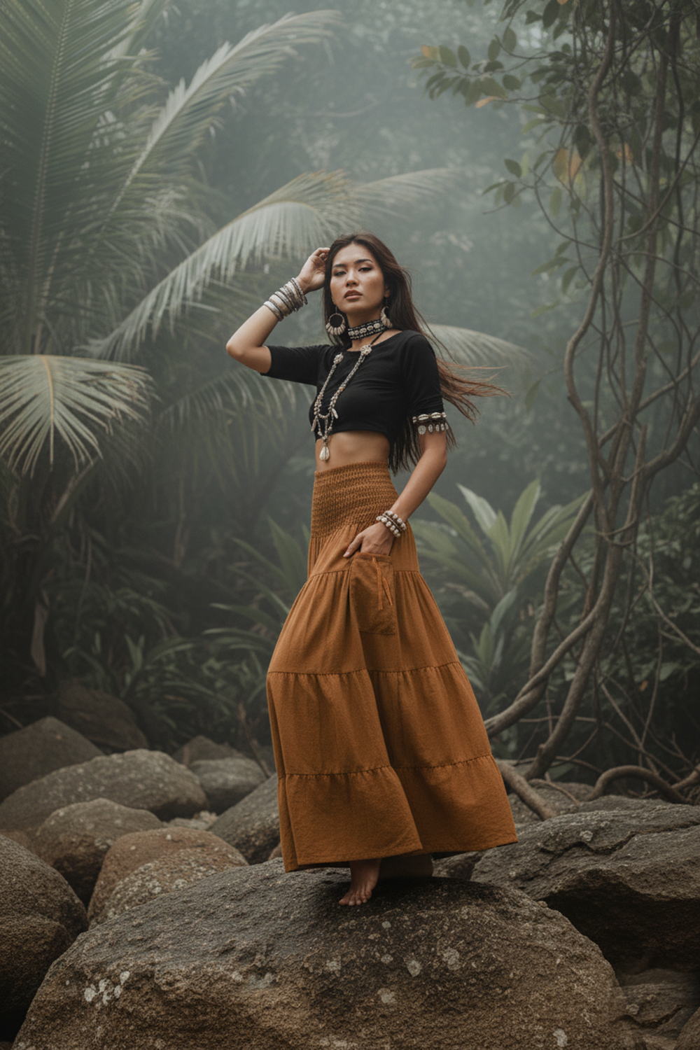Woman in black top and brown skirt standing on a rock with a forest background