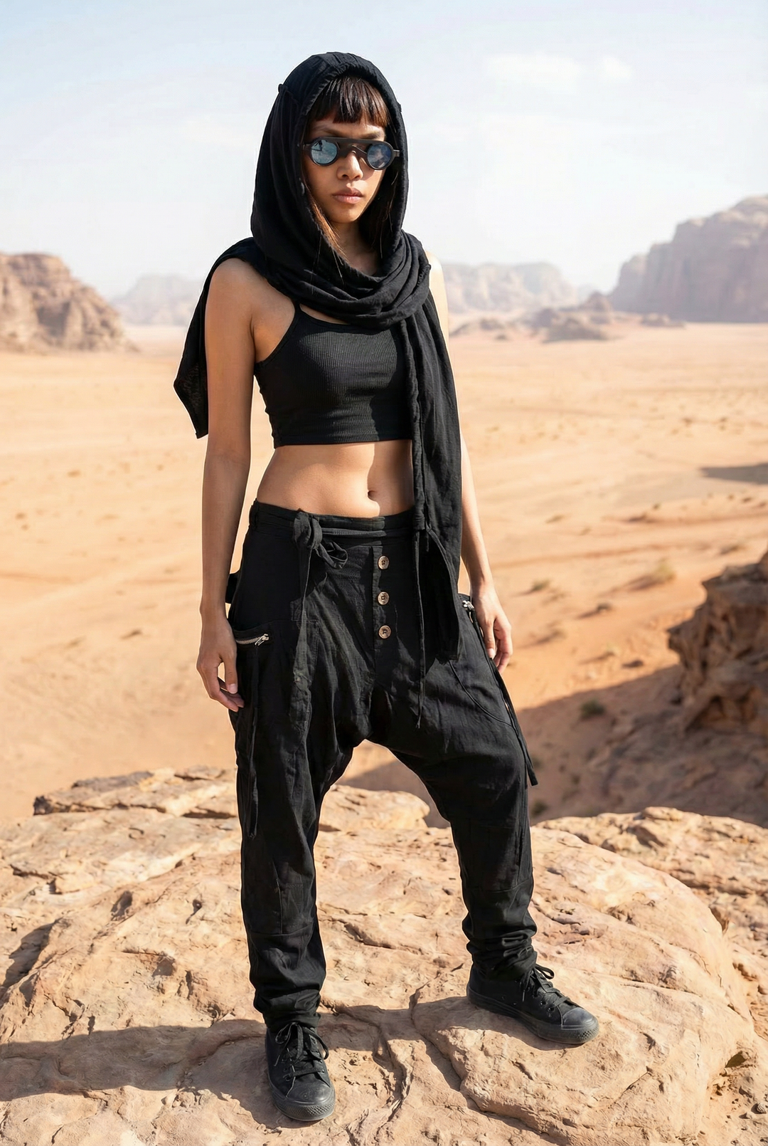 Person in black outfit standing on a rocky desert landscape