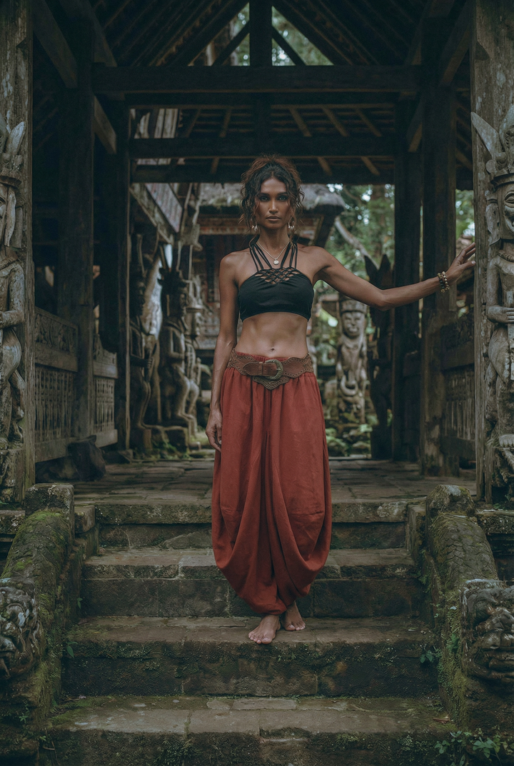 Woman in traditional attire standing on stone steps in a temple setting